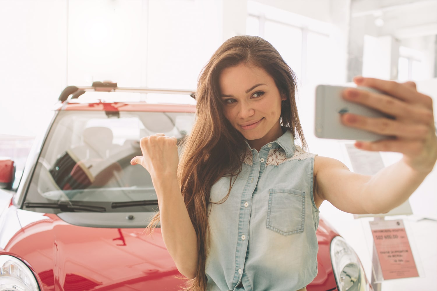 Teen driver taking selfie with car