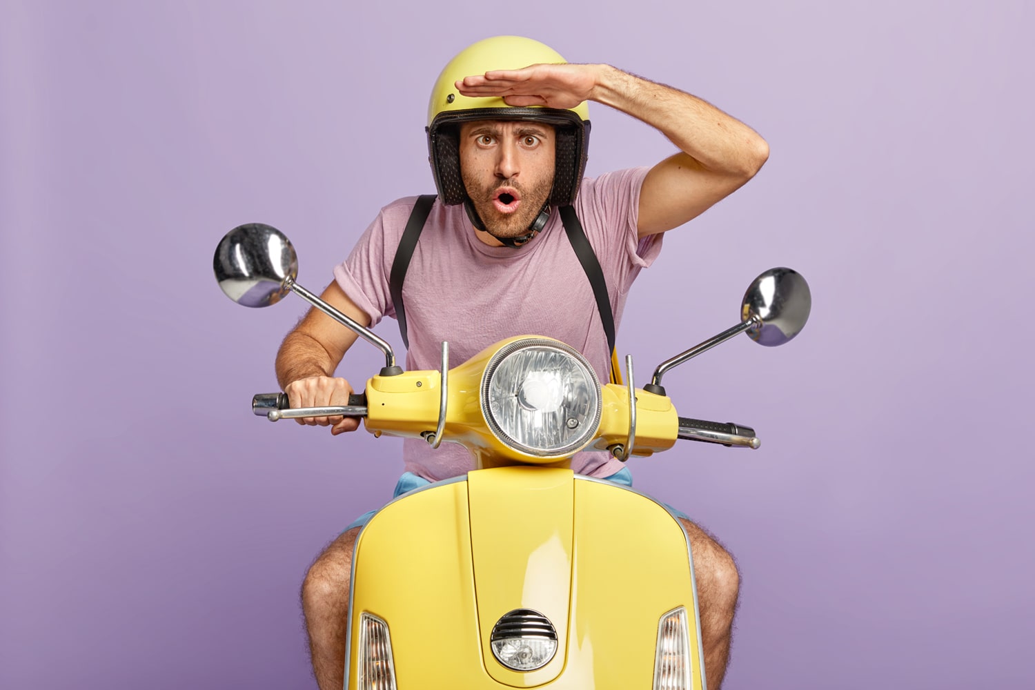 man on scooter wearing helmet