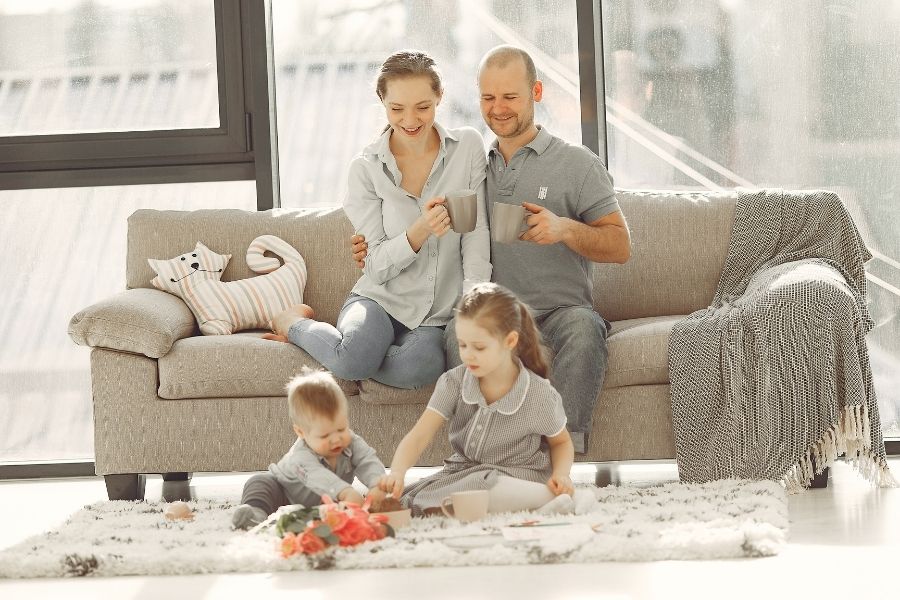 mother, father, son and daughter in living room