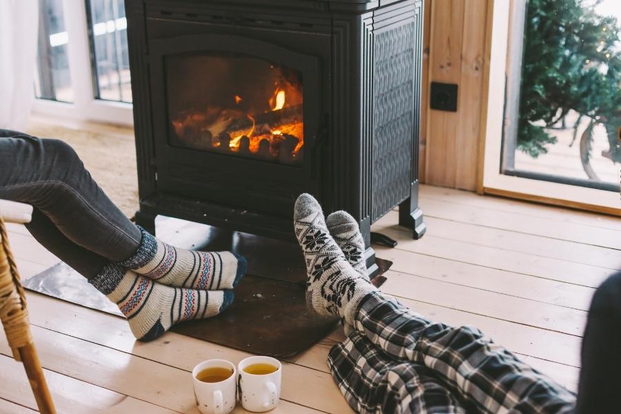 relaxing beside fireplace in winter
