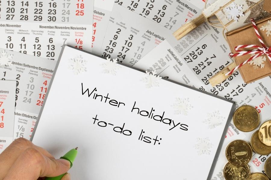winter holidays to-do list on top of calendars and snowflakes