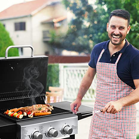 man barbecuing on gas grill
